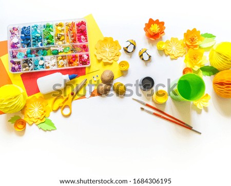 The child makes a bee crafts. Paints and material for creativity. Kindergarten and school. White background