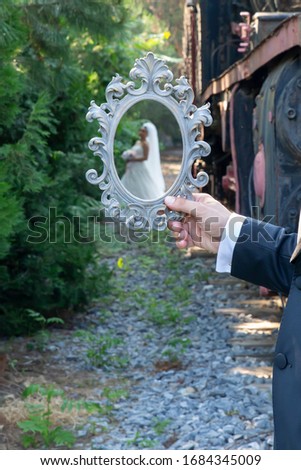 bride and groom concept,  posing with vintage frame