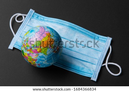 on a medical bandage lies a mock planet Earth, the concept of a global pandemic of the coronavirus, on a black background