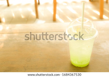 Close-up pictures of green apple italian soda on wood table.