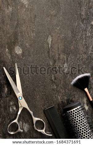 Hair salon accessories on black marble background. Hair salon, beauty salon concept. top view, flat lay