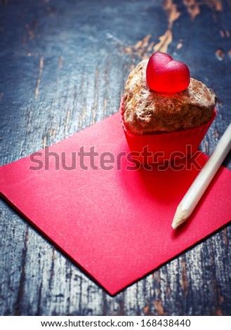 "Happy Valentines Day" messages o with chocolate cupcake against a rusty wooden background for a stylish, fun and cheerful Valentines Day.