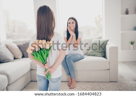 Oh dear its so sweet, Positive cheerful mother sit comfort couch enjoy admire her little daughter prepare bloom blossom roses bouquet for 8-march celebration in house indoors