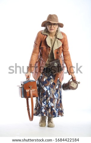 archetype, portrait of a woman traveler in a hat, jacket, glasses and with bags on a white background