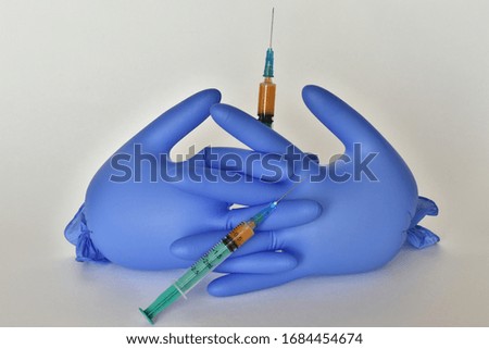 
syringe in hand isolated on a light background with copy space. gloves hold a syringe in hand isolated on a white background. gloves hold a syringe ready to inject for treatment.