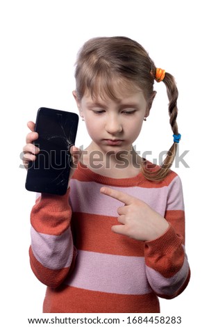 Cute little girl with broken smartphone on white background