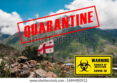 Waving Flag of Geogia on the background of the Caucasian mountains. Travel vacations cancelled. Coronavirus pandemic. Worldwide borders closures. Danger of infection covid -19. Kazbegi, Georgia