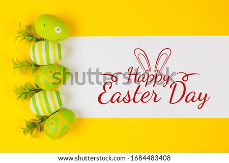 Decorted Easter eggs in a bird's nest on a yellow background