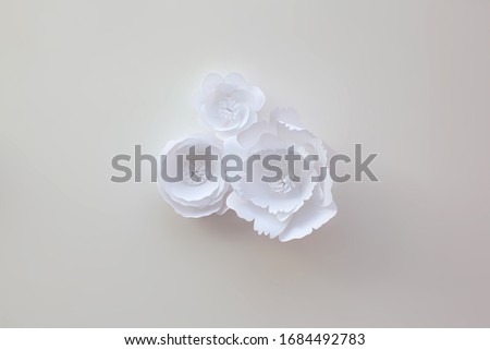 Handmade paper art and cut white flowers on white background. 