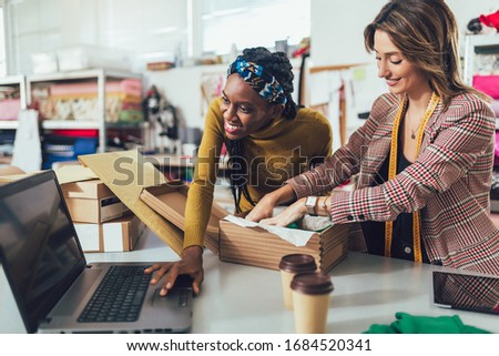 Sales Online. Working women at their store. They accepting new orders online and packing merchandise for customer. Royalty-Free Stock Photo #1684520341