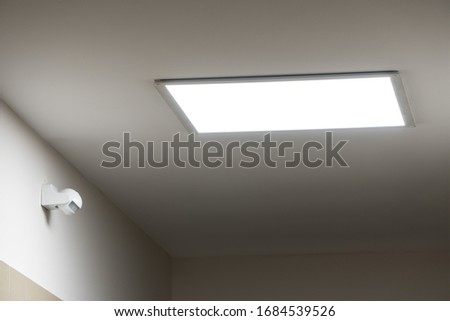 Large led lighting panel on the ceiling in a modern residential complex. Power saving. Motion sensor. Lighting in non-residential premises and public places. Bright light Royalty-Free Stock Photo #1684539526