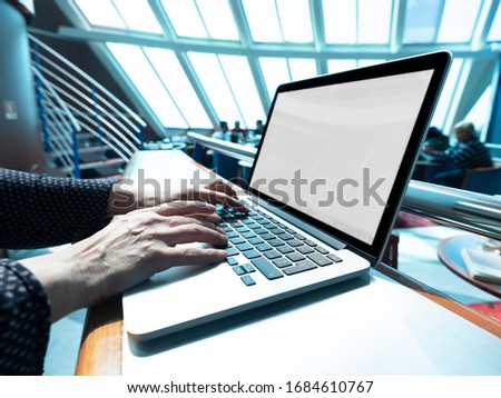 Woman working on laptop while traveling on a ship. Copy space screen background for your text message