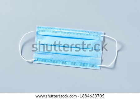 Surgical mask for cover mouth and nose on gray background. Concept of protection, virus epidemic or pandemic, corona virus, covid-19 Royalty-Free Stock Photo #1684633705