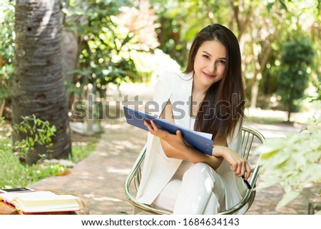 Beautiful business asian woman sit and work in the garden,