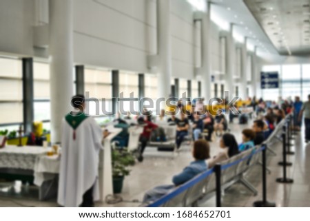 Blurred photo of an ecclesiastical mass ceremony at an airport or large open space.