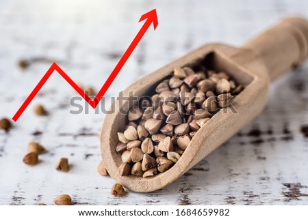 Buckwheat groats macro and arrow showing rise in price of buckwheat. increase in the price of buckwheat, quarantine, coronavirus