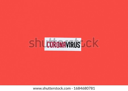top view of card with coronavirus lettering isolated on red