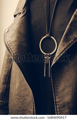 Leather jacket with metal jewelry, fashion grunge style photo