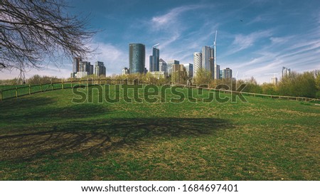 Skyscrapers in London and meadow in spring
