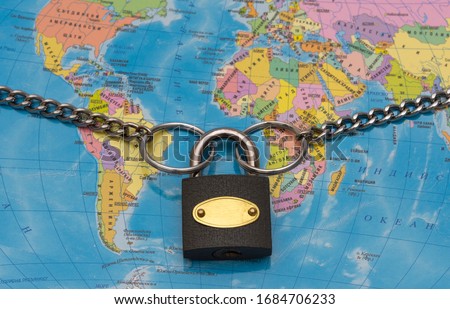 Chain And Padlock On A Blurred World Map .Coronavirus ,covid-19 - global security concept.