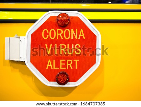 Coronavirus warning text on school bus stop sign.