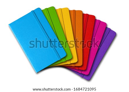Multi color closed notebooks range isolated on white
