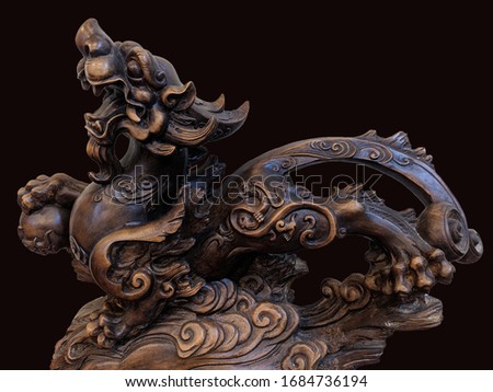Wooden chinese lion isolated on black​ background