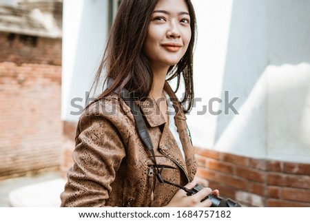 attractive woman photographer taking picture using camera while traveling in the old city