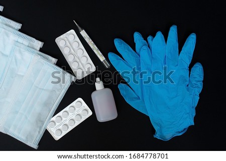 A protective masks and gloves on a black background