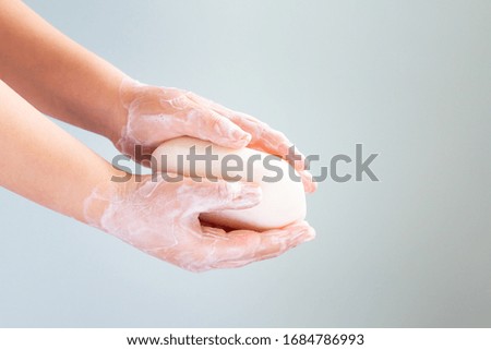 Closeup of child washing hands isolated on light background.  Cleanliness and body care concept. Copy space