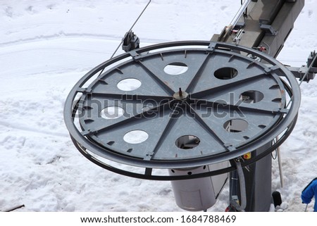Chair lift machine in snow closeup 