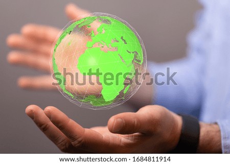 Human Hand Holding The World In Hands
