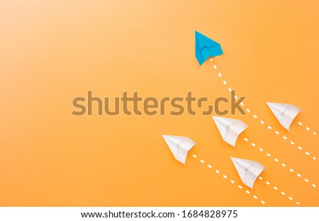 New ideas creativity and different innovative solution. Business concept. A group of paper airplanes, one plane is flying in the other direction, different way.