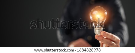 Creative new idea. Innovation, brainstorming, inspiration and solution concepts. The man is holding light bulb. Copy space background. Royalty-Free Stock Photo #1684828978