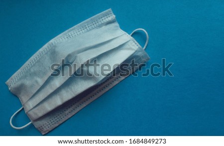 Medical mask for virus protection. Disposable mask. On a blue background. Copy space
