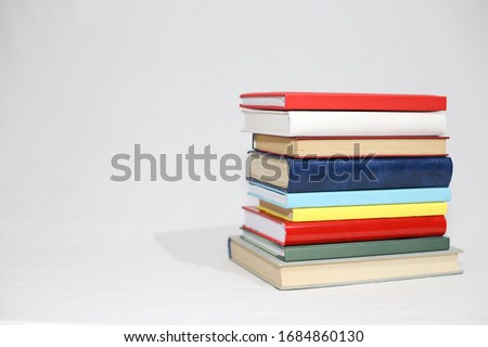 Stack of books on white background Royalty-Free Stock Photo #1684860130