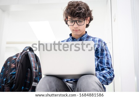 Close up young student using laptop