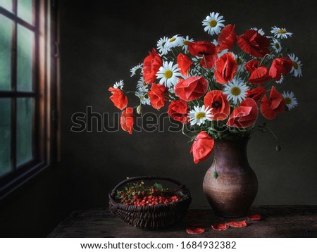 Rural still life with splendid bouquet of summer's flowers and strawberry