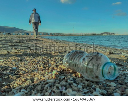 an old man walking on the seashore