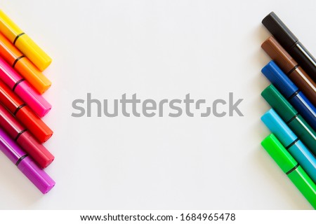 color markers lie on a white background.copyspace for text.