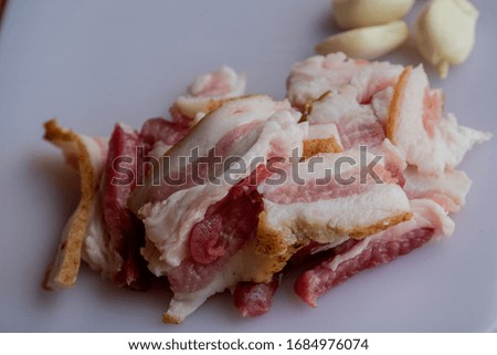 Garlic and bacon.Bacon and garlic. Bacon and garlic on a table on a blackboard. Food photography.