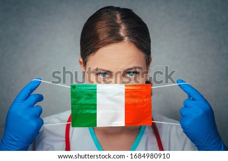 Coronavirus in Ireland Female Doctor Portrait hold protect Face surgical medical mask with Ireland National Flag. Illness, Virus Covid-19 in Ireland, concept photo