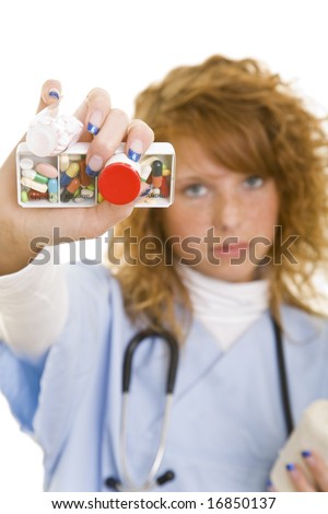 Young redheaded woman wearing a lab coat holding medical supplies