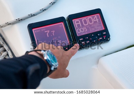 Modern sailing yacht controls - tridata and autopilot displays, showing speed, depth and course. Scotland sailing trip. Royalty-Free Stock Photo #1685028064