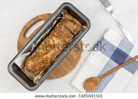 Minced meat meatloaf baked and served on the table