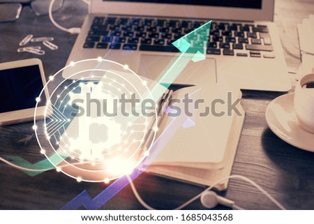 Double exposure of blockchain theme drawings and desk with open notebook background. Concept of Crypto currency