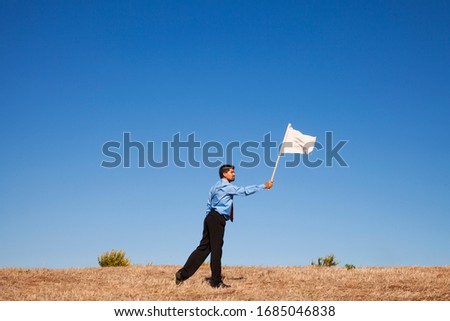 businessman asking for surrendering holding a white flag