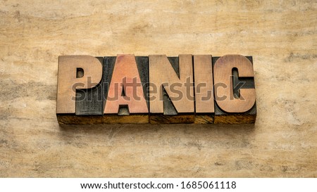 panic word abstract in vintage letterpress wood type against grunge handmade paper, sudden uncontrollable fear or anxiety Royalty-Free Stock Photo #1685061118
