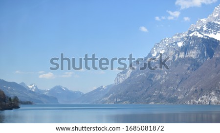 Wide angle landscape view of the Swiss Alps in Switzerland with water.