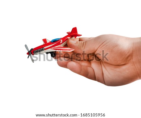 Isolated photo of hand holding race sport airplane toy on white background side view.